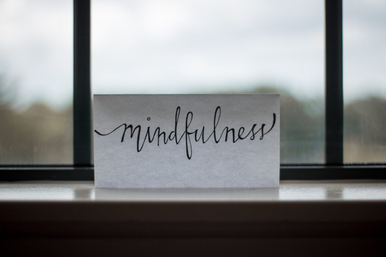 The word mindfulness is written on a piece of paper, representing one of the key things in building CSR strategies.