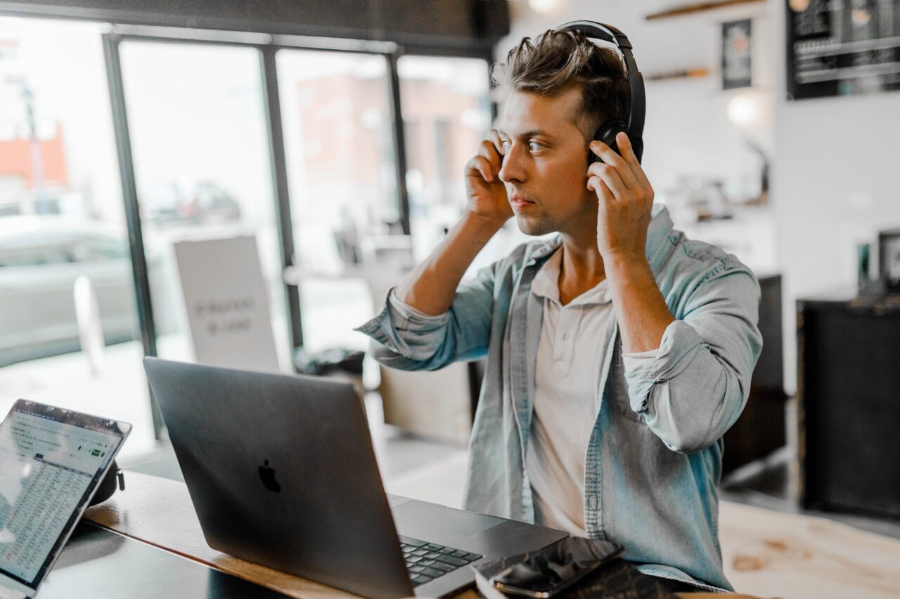 an image showing a guy in a contact centre with his headphones