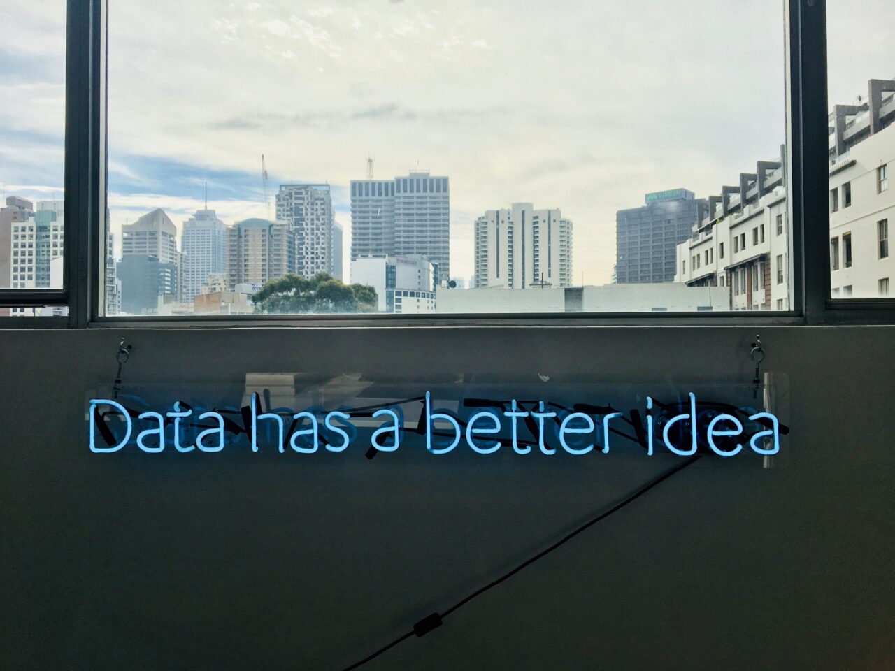 A neon sign shows words: data has a better idea of a winning customer experience.