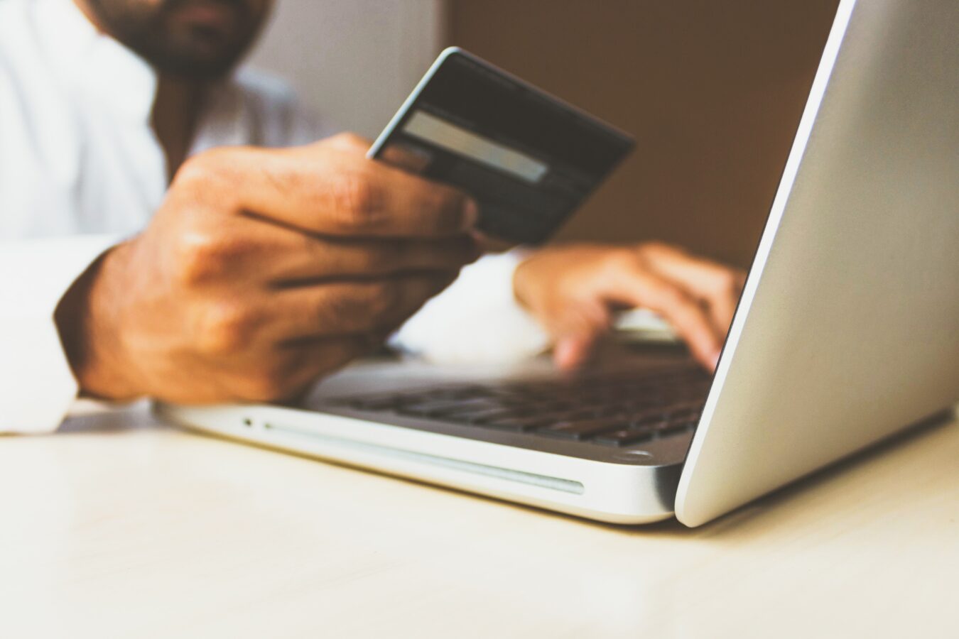 Man using a credit card for online retail services