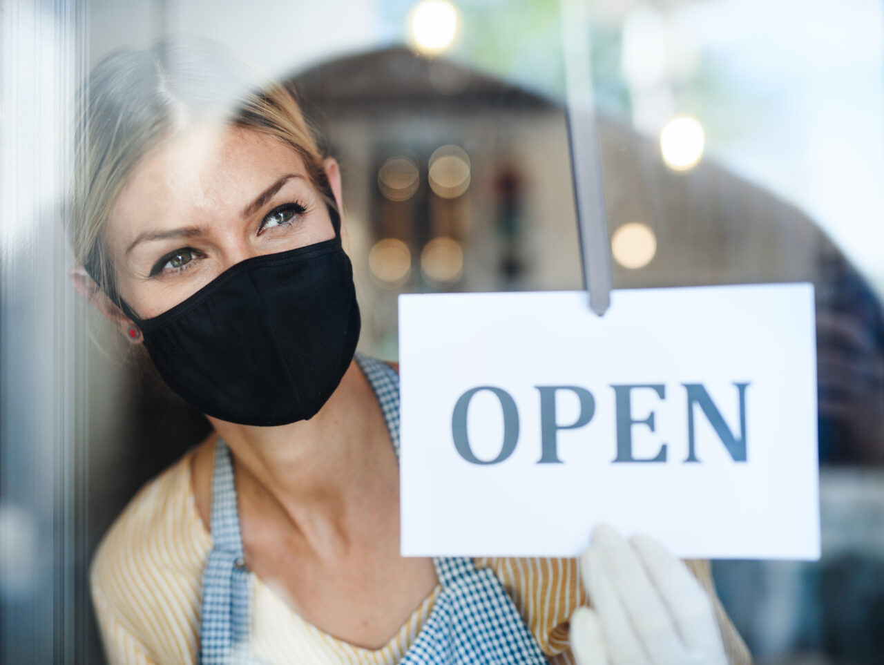 A young woman with the face mask demonstrates how stores can prioritize consumer well-being