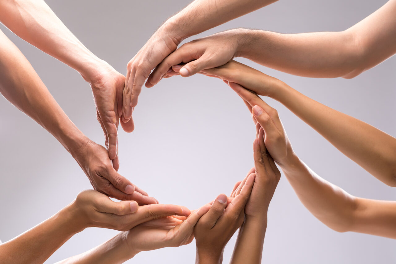 an image of peoples' hands showing trust as a the way of building a culture of innovation. 