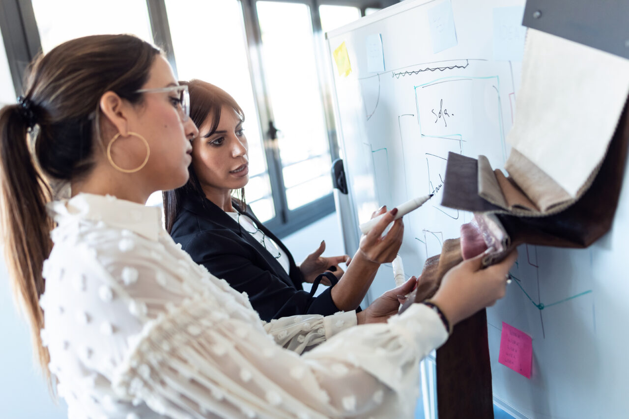 an image showing two women designing a customer service process. 