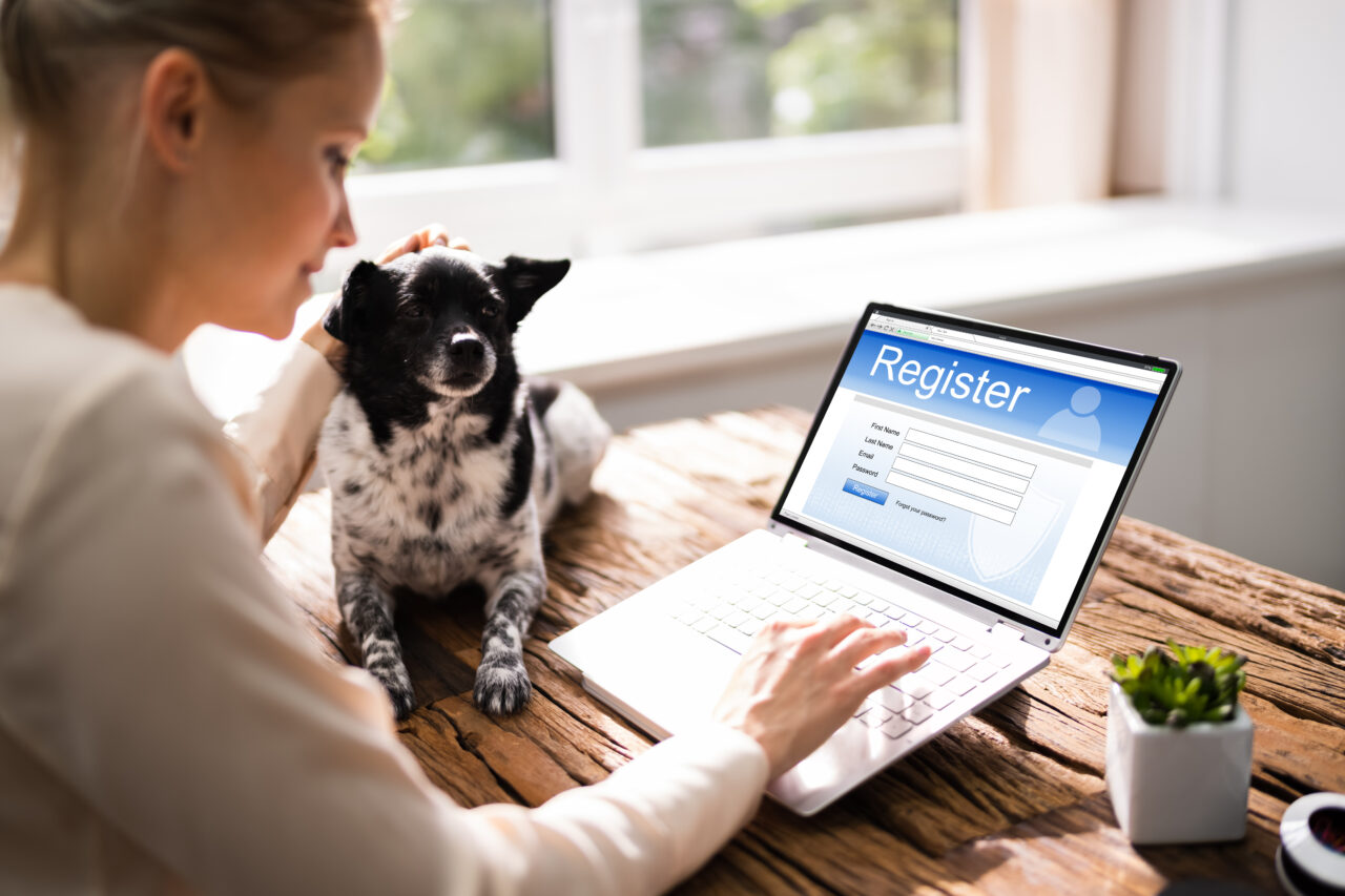 an image showing a woman and her dog making a registration online. 