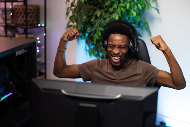 Man playing a PC gaming and winning 