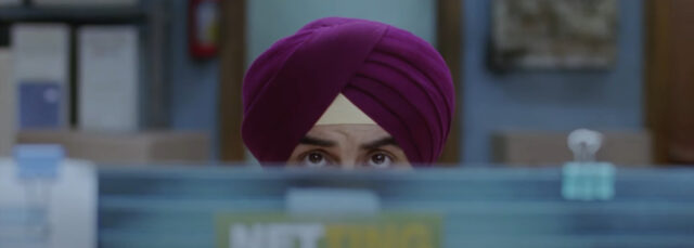 close up of lead character look over his work cubic in "Rocket Singh: salesman of the Year" (2009) one of the business movies about sales