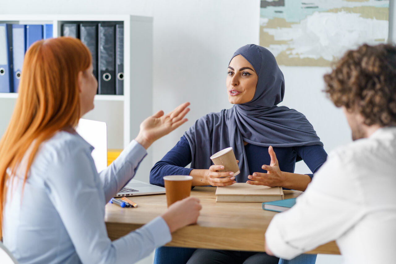 an image showing a women with the blue scarf leading a conversation about safety in the workplace. 