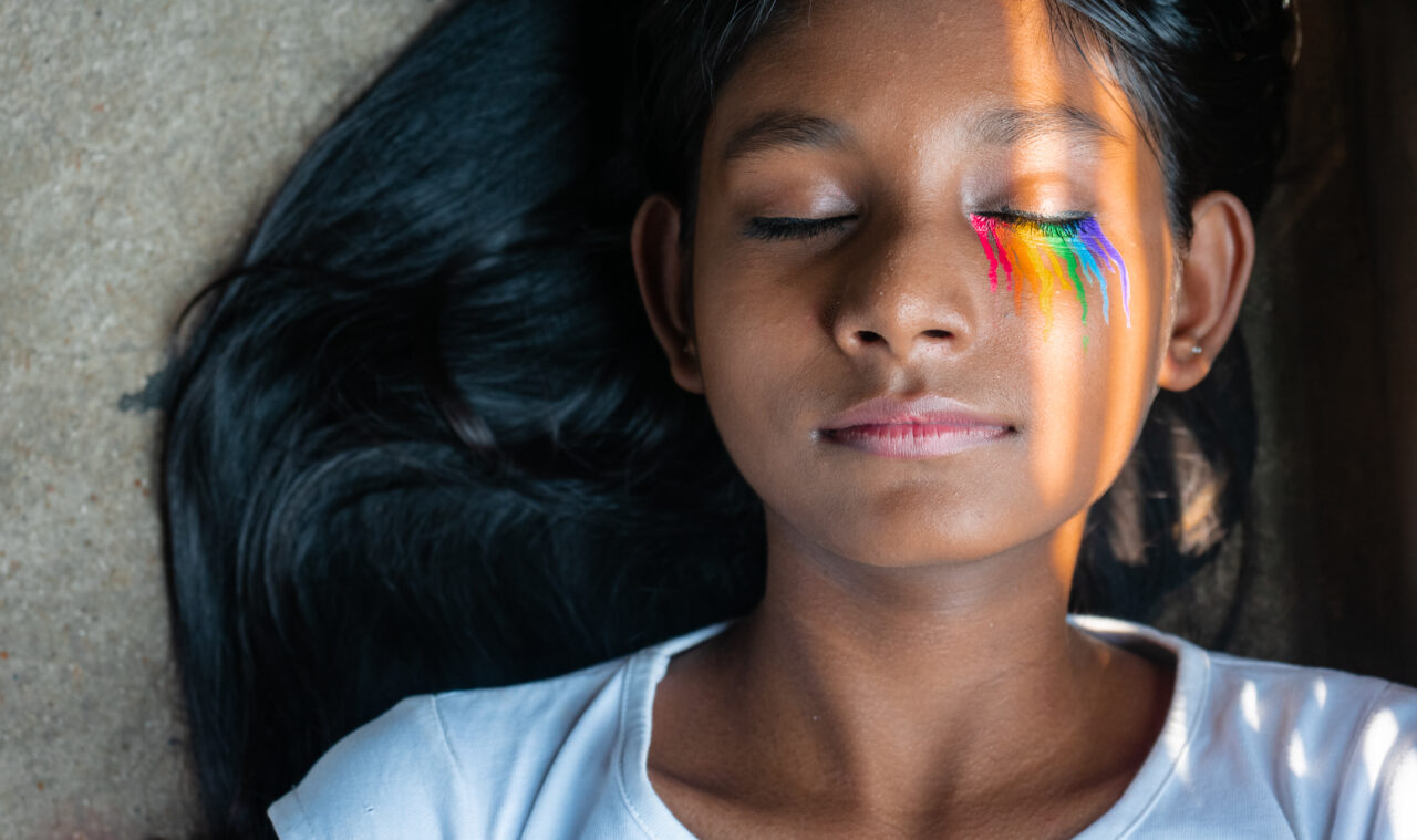 an image showing a child with a rainbow under her eyes as a call for building ethical technology and diversity. 