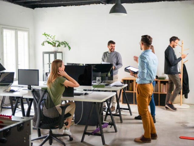 group of people working in a open plan office