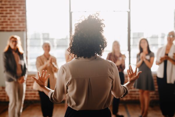 African american female empowering other colleagues in workplace