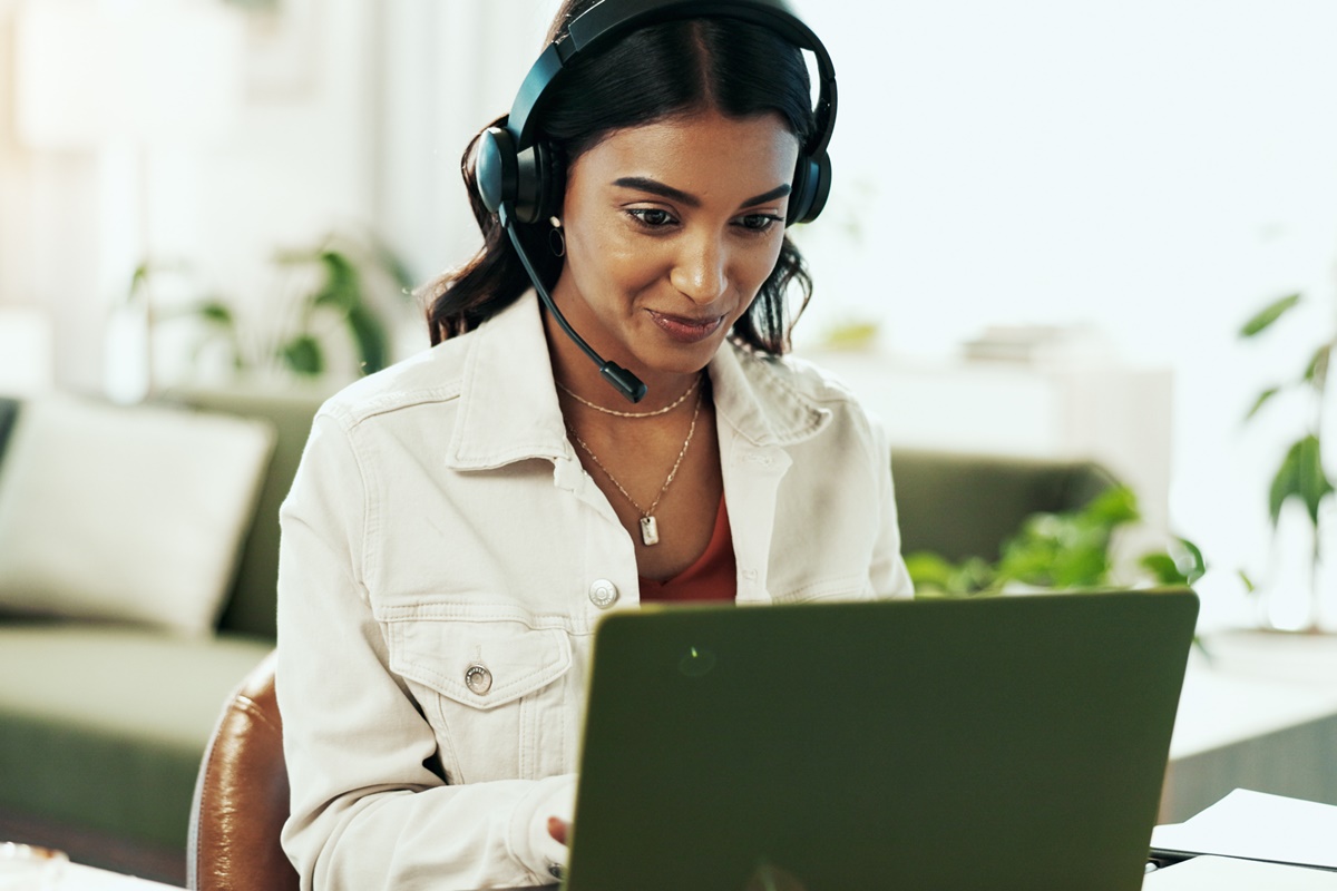 Woman, laptop and support with headphones in call centre for customer service